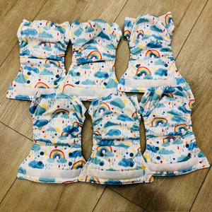 Thristies newborn all in one cloth diaper, natural fiber inner, shown in rainbow print, gently used