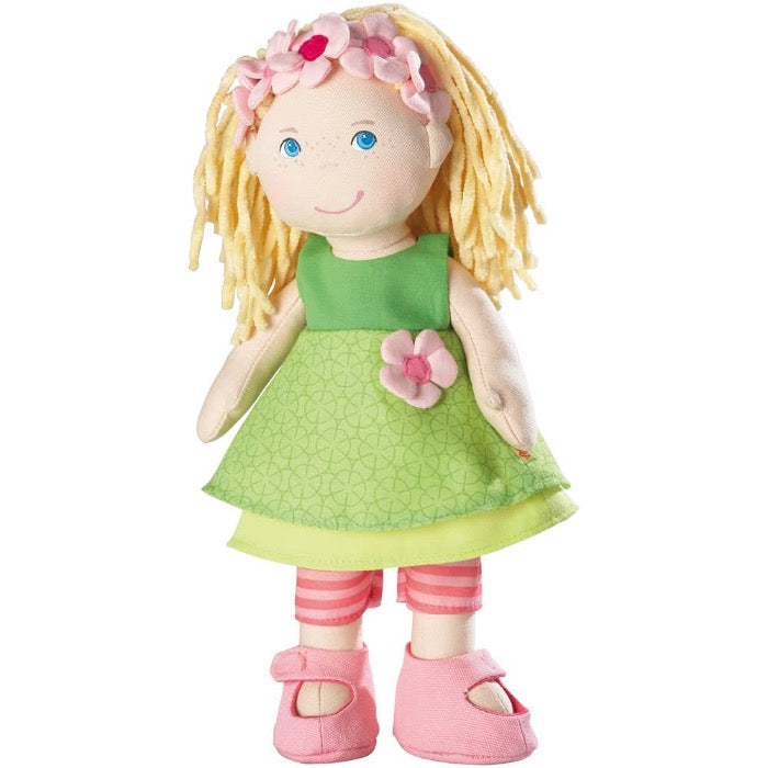 haba 12 inch doll mali wears a lime green dress, with pink striped leggings and pink shoes