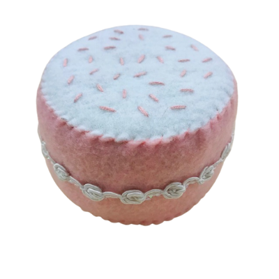 handcrafted felt small white cake with two pink flower decorations
