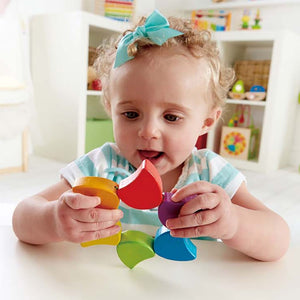 The Hape Rainbow Rattle pieces can be moved to form a different design