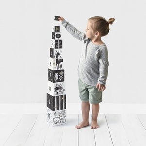child stacking the ten wee gallery woodland nesting blocks