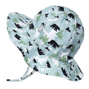 Cotton floppy hat by jan and jul in bear print, black bears, pine trees and mountains on a pastel pine tree background
