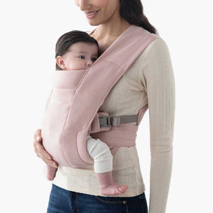 Ergobaby Embrace Carrier in black, shown on man wearing baby