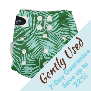 gently used Imagine Stay-Dry One-Size All-in-One Diaper in palm beach print with light blue palm fronds on green background