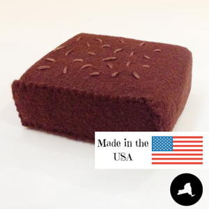 Close up of made in NY and USA felt brownies that measures 3" x 2 1/4" x 1"
