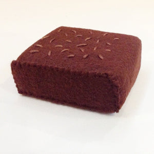 Close up of made in NY and USA felt brownies that measures 3" x 2 1/4" x 1"
