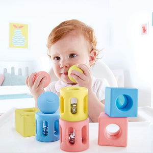 hape geometric trio rattle set contains 9 pieces in blue, yellow, and pink
