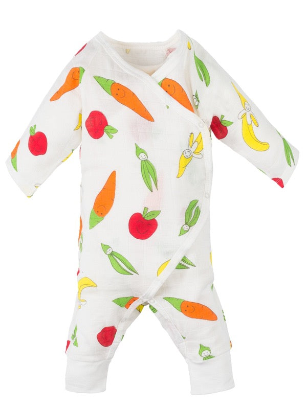 Under the Nile Organic Cotton Muslin Fruit and Veggie print on white, side snap style kimono one piece outfit for infants, show on baby with banana toy
