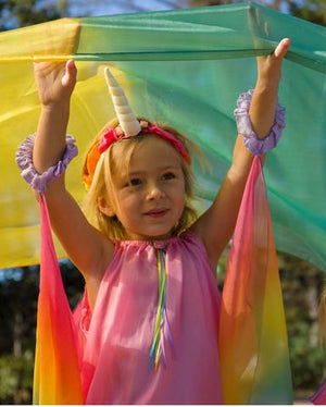 child wearing rainbow unicorn horn band and other sarah's silks