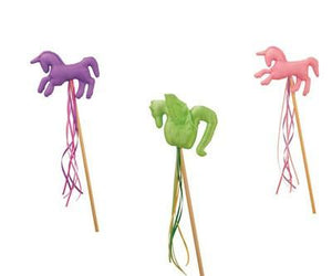 lavender unicorn, pink unicorn, and green dragon on their magical wood wands
