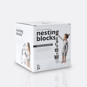 child stacking the ten wee gallery woodland nesting blocks