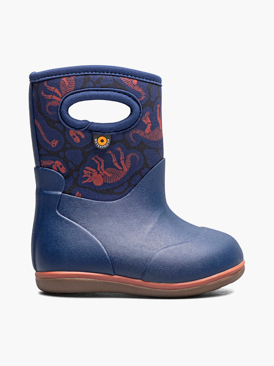 A single toddler's winter boot in navy blue with a patterned upper featuring red and orange sea life motifs, a handle cutout, and a brown sole, shown against a plain white background. Made by Bogs brand, baby classic model