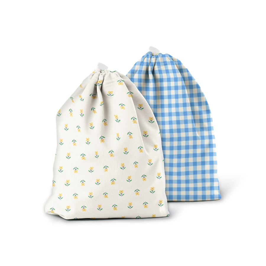 Three drawstring wet bags with fruit-themed patterns on a white background