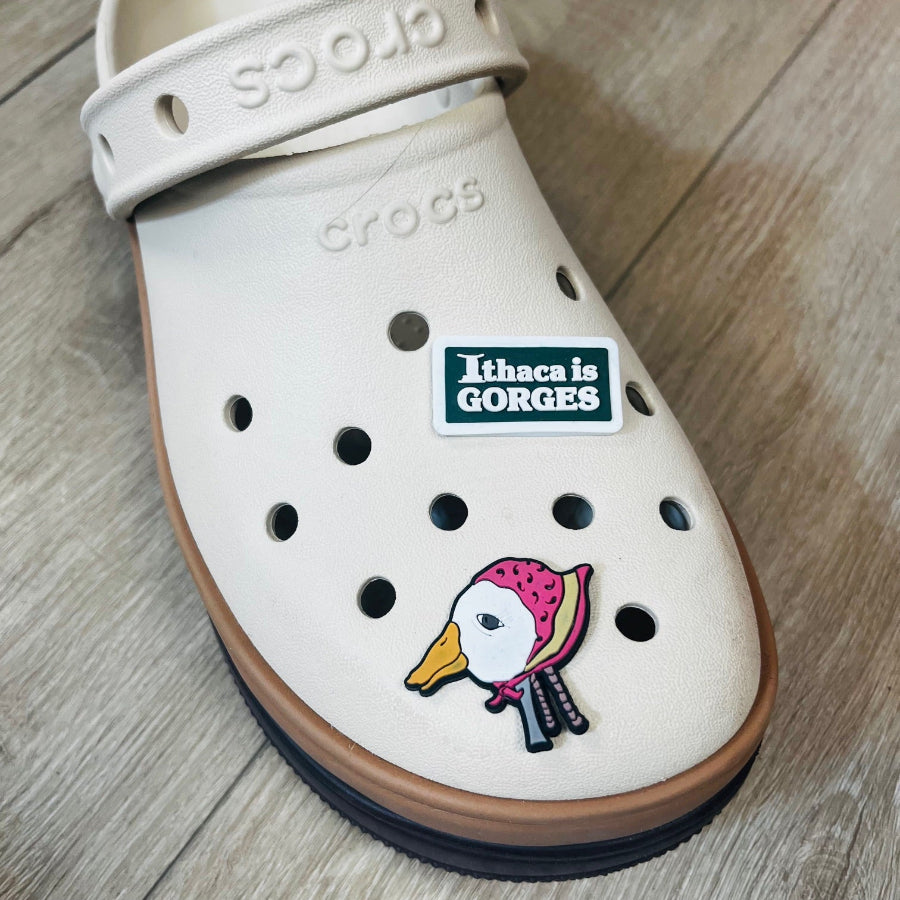 Rectangular shoe charm with 'Ithaca is GORGES' text on a white background