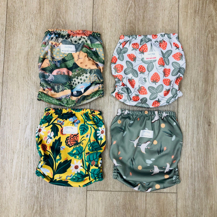 4 pack of Esembly diaper covers in size 2, gently used