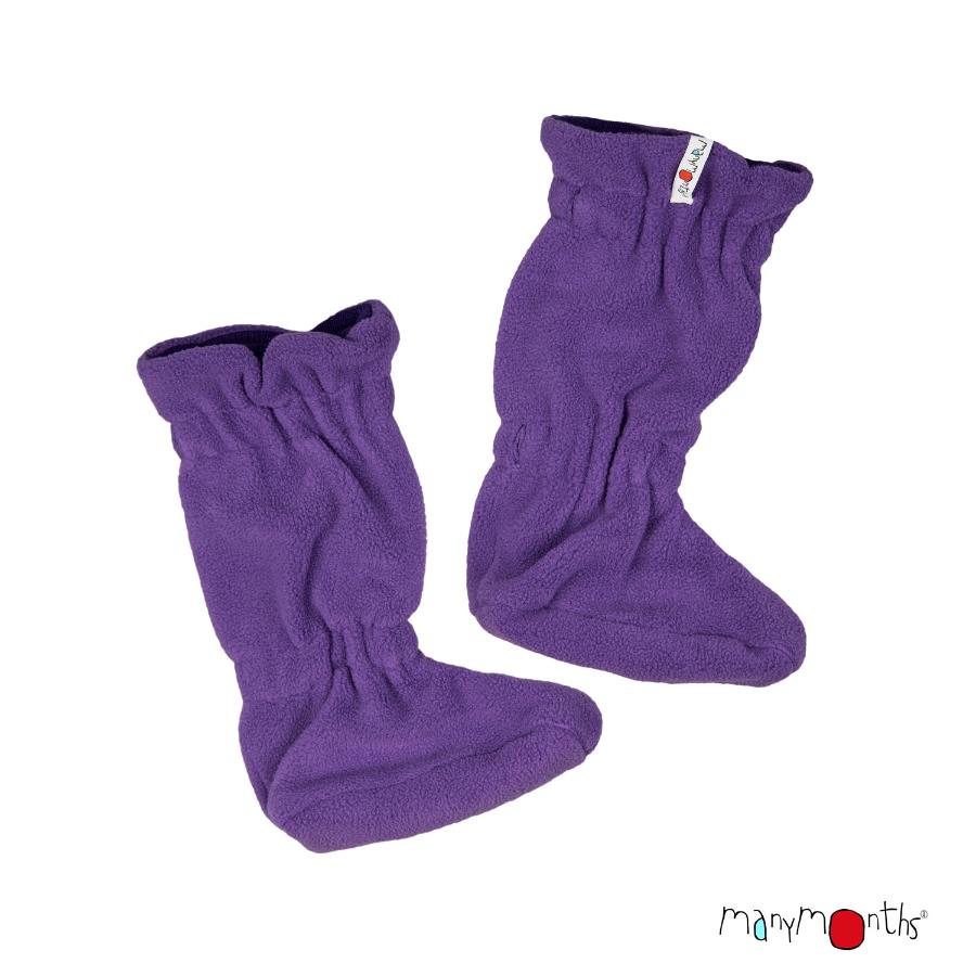 A pair of callisto moon brown fleece baby booties with ribbed knit wool cuffs, shown on a light gray background. One bootie is upright and the other is folded down, showing a small white brand tag on the cuff. ManyMonths brand logo in bottom right corner