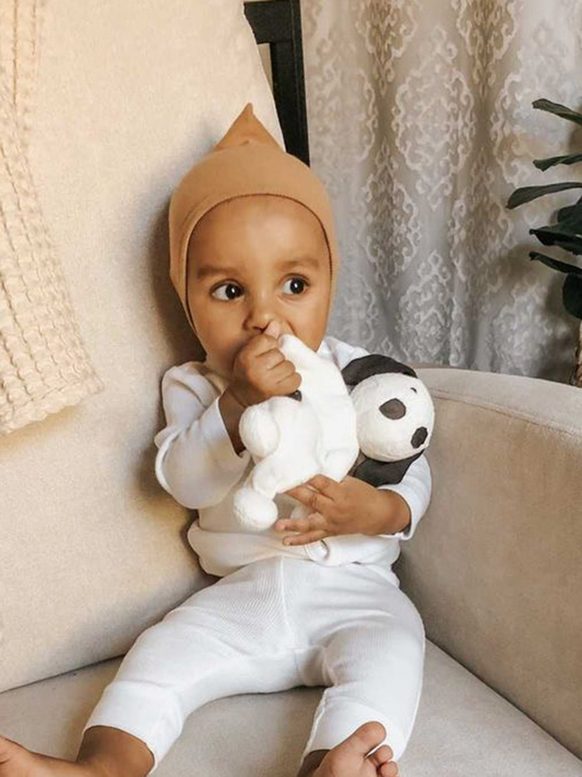 organic cotton White plush baby toy dog with black spots on a white background