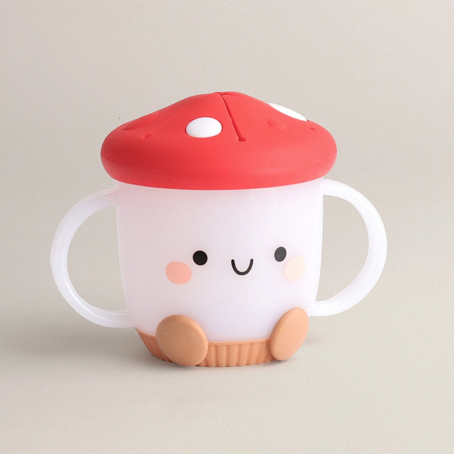 Children's snack cup with a red lid and cute face design on a beige background, mushroom theme, made by Itzy Ritzy brand