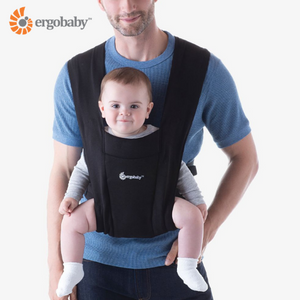 Ergobaby Embrace Carrier in black, shown on man wearing baby