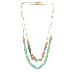 Metropolitan Necklace is great because it has two strands (we love the fashion of multiple strand necklaces!) with different bead selections on each, including a couple of natural wood beads and various sizes and shapes of silicone beads and can be worn separately or together as strands. . Shown in mint green and tan color scheme.