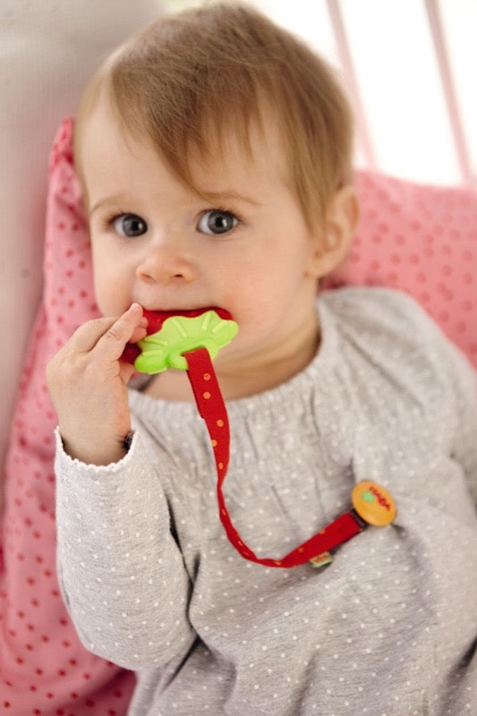 Haba Strawberry Clutching Toy & Teether is red and green with detachable ends and made from food grade silicone