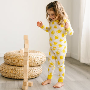 child dancing in a two piece viscose pajama set in bananas print