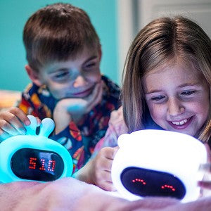 two children with their lumiclock alarm clocks