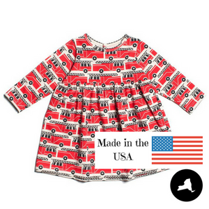 Geneva baby dress with red firetrucks is made from 100% organic cotton and made in the USA
